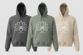 White lotus hoodie in three colorways: charcoal, sage green, and cream