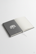 Blank hardcover journal with white lotus design on charcoal cover